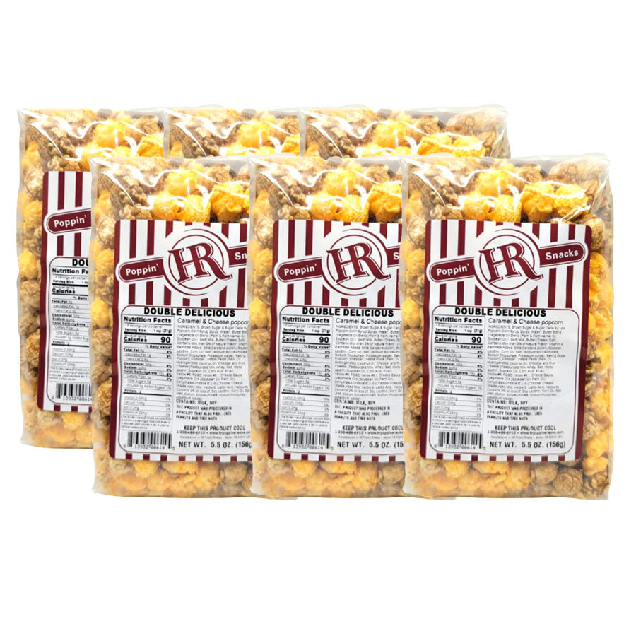 Six packages of Poppin' Snacks Double Delicious popcorn on a white background