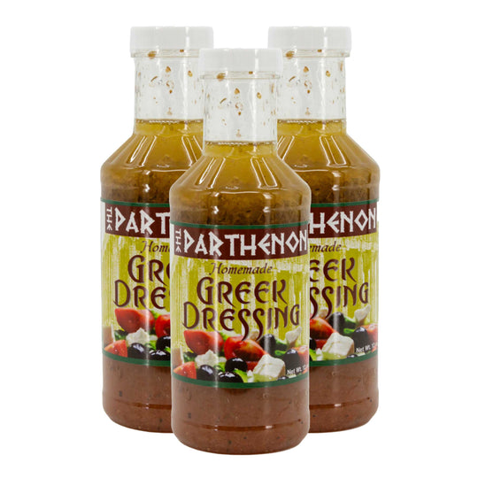 Three bottles of Parthenon Greek dressing on a white background
