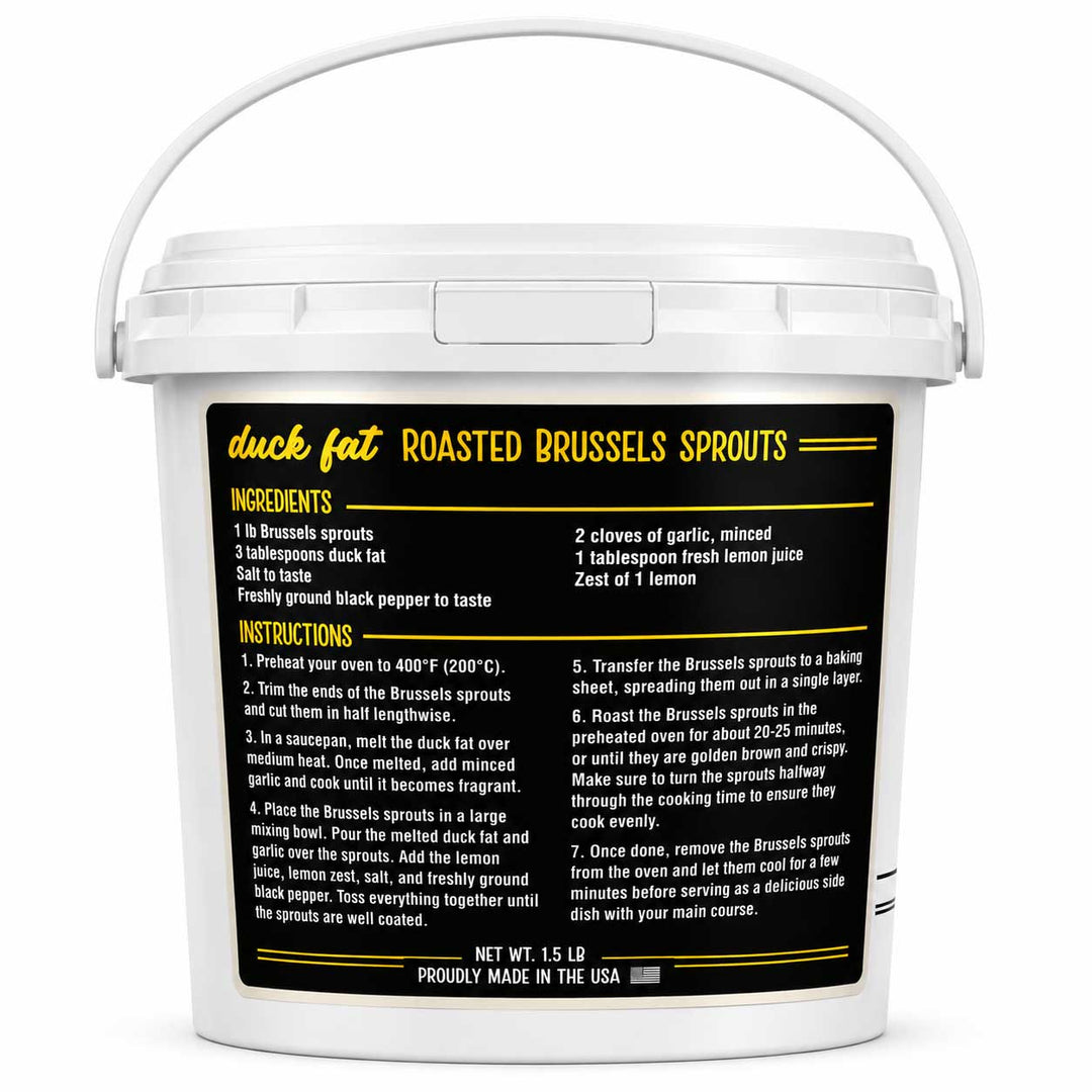 A white plastic bucket with a handle, featuring a large black label with yellow and white text detailing the ingredients and instructions for making duck fat roasted Brussels sprouts.