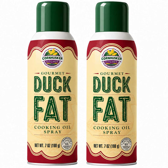 Two 7 oz cans of Cornhusker Cooked Gourmet Duck Fat Cooking Oil Spray side by side on a white background.