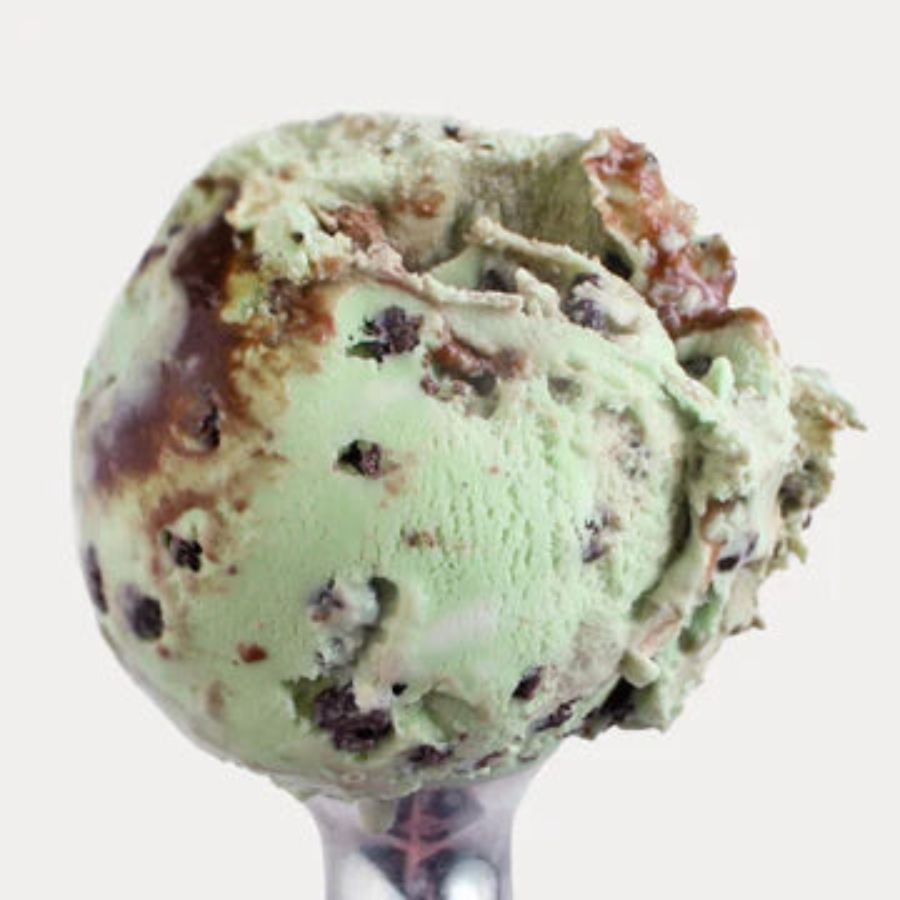 A scoop of Mint Cookie Crunch Ice Cream on a white background