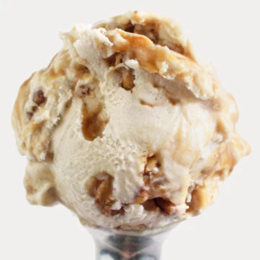 A scoop of Praline Pecan Ice Cream on a white background