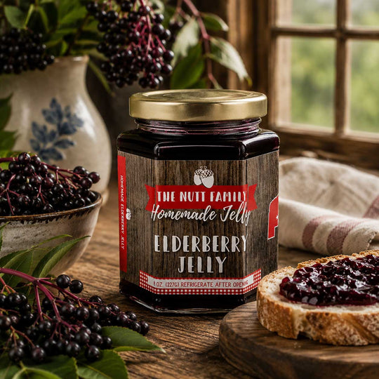 Jar of homemade elderberry jelly on a wooden table with fresh elderberries and a slice of bread.