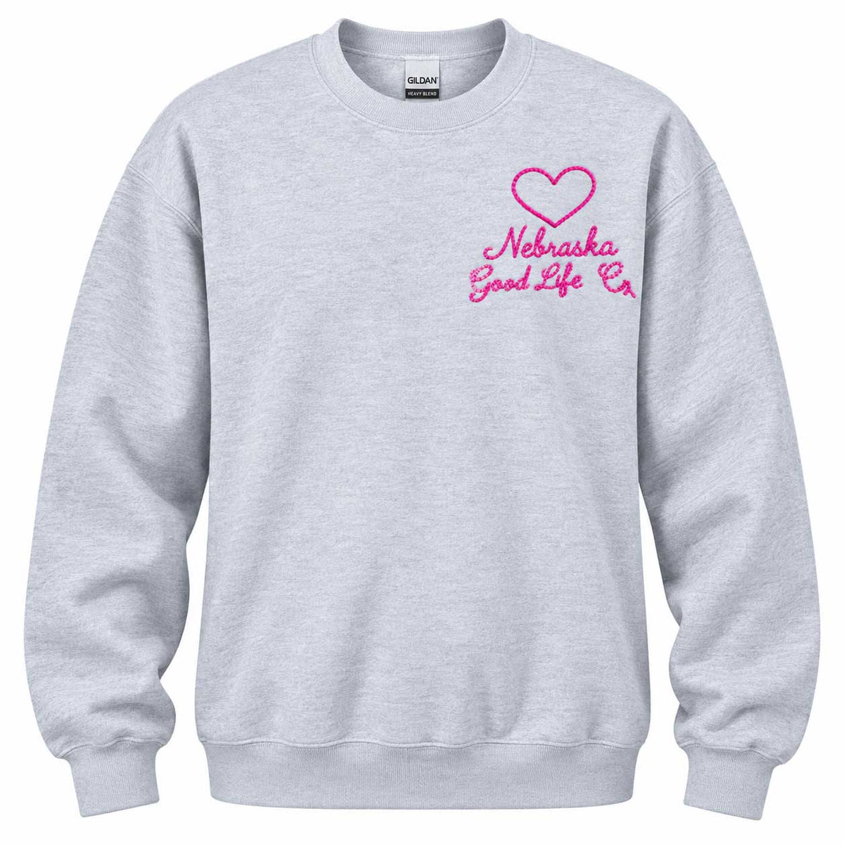 A light heather gray crewneck sweatshirt featuring a pink embroidered heart and the text 'Nebraska Good Life Co' on the left chest, displayed on a clean white background.