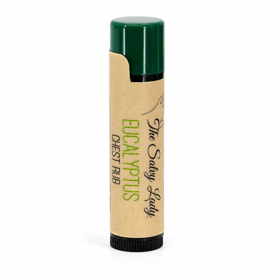 Balm stick with green cap and brown body on a white background