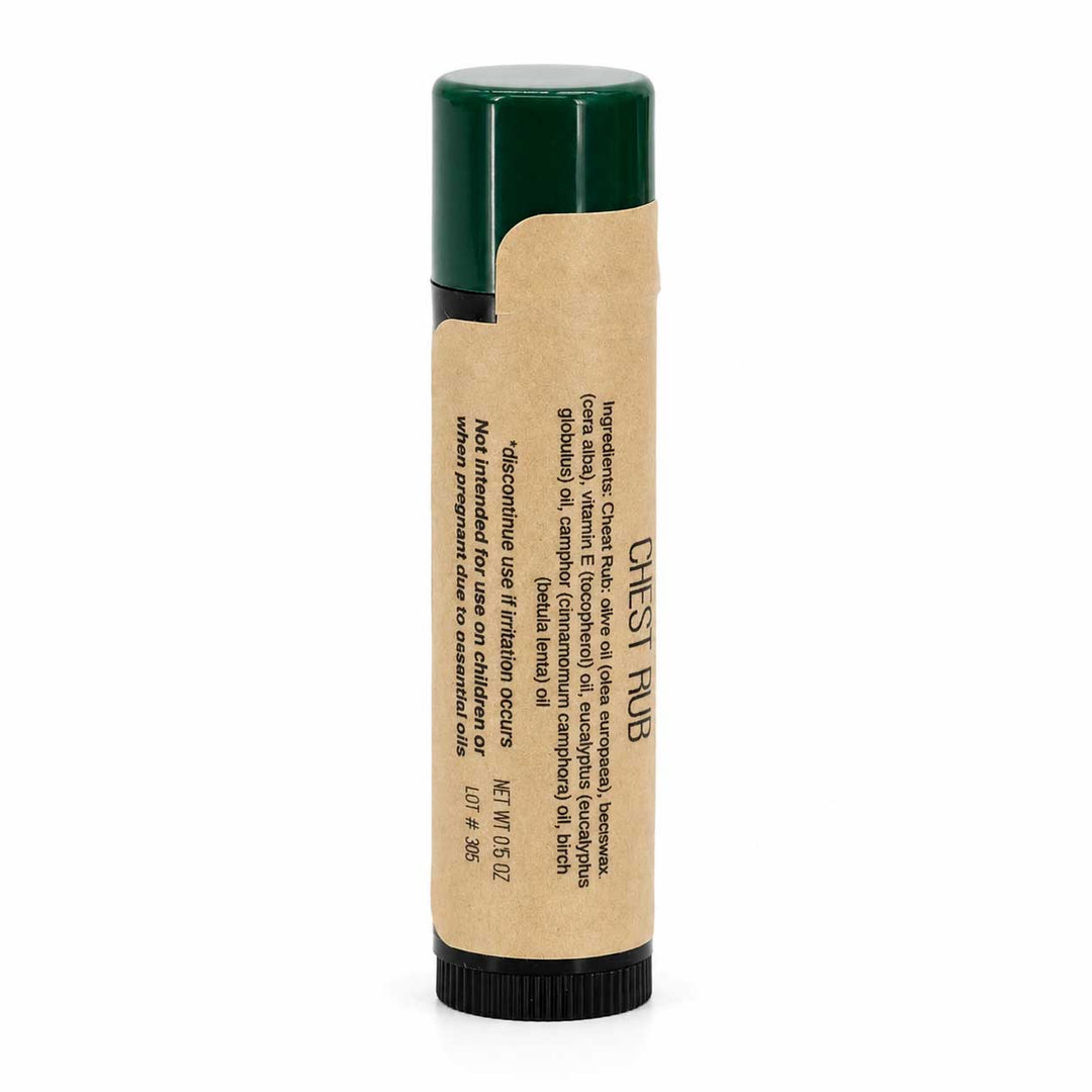 Balm stick with green cap and brown paper wrapper on a white background