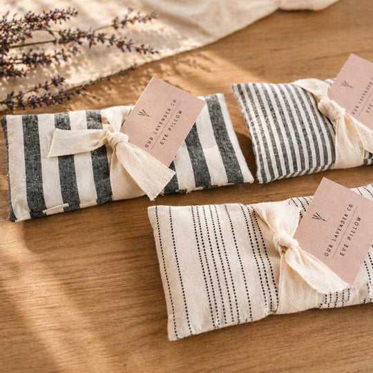 Striped eye pillows with lavender on a wooden surface