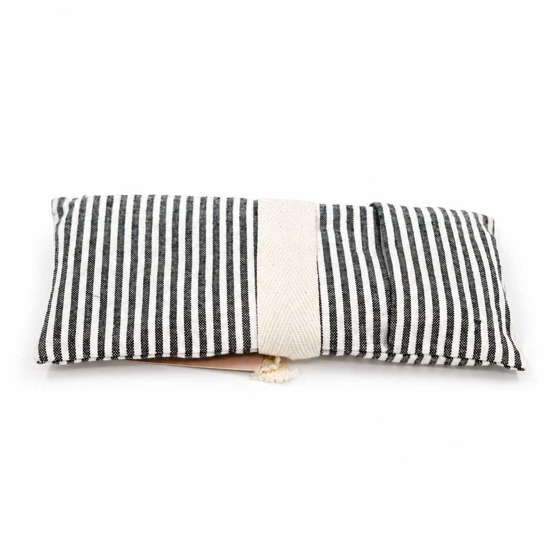 Black and white striped pillow on a white background