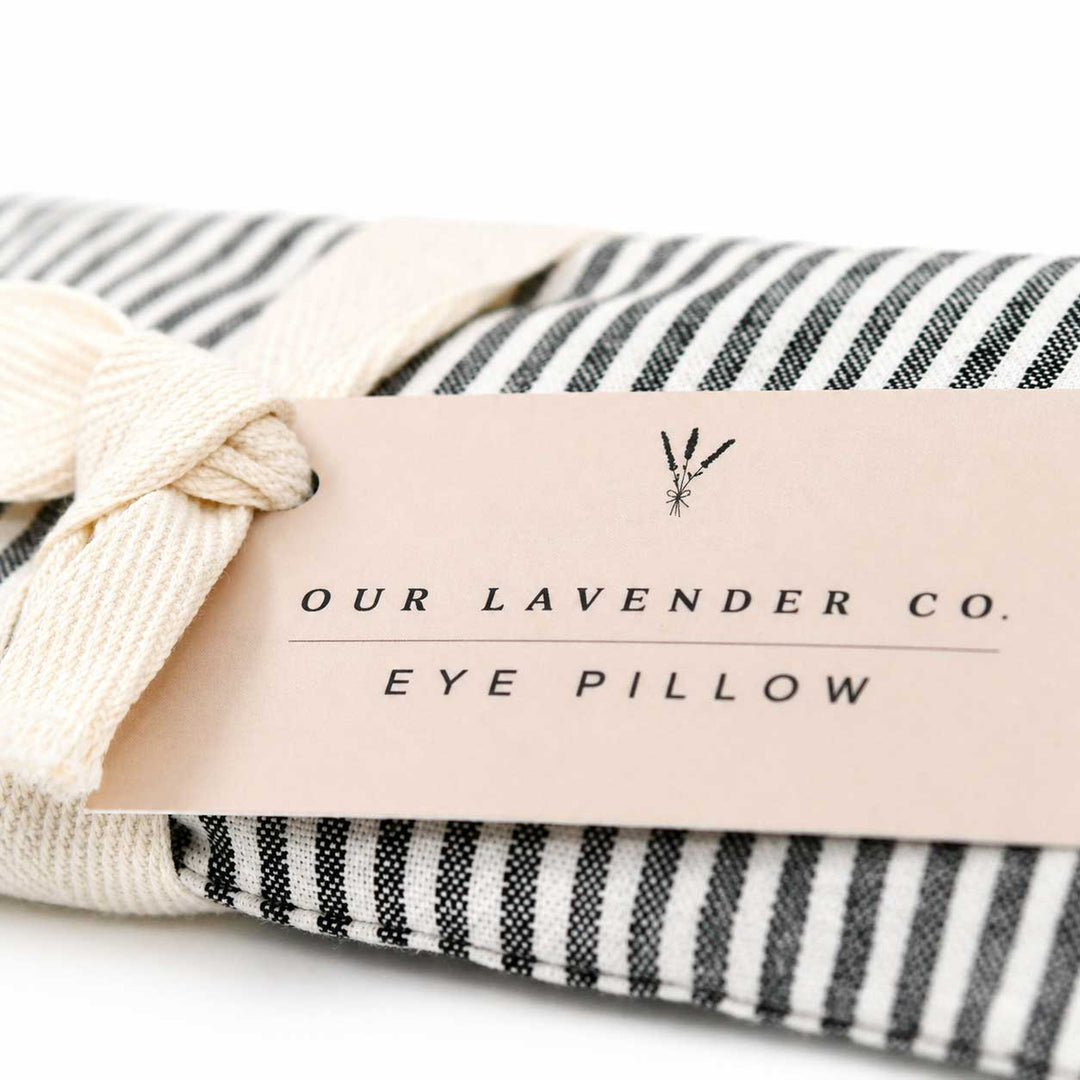 Eco-friendly eye pillow with striped cover and 'Our Lavender Co.' label on a white background