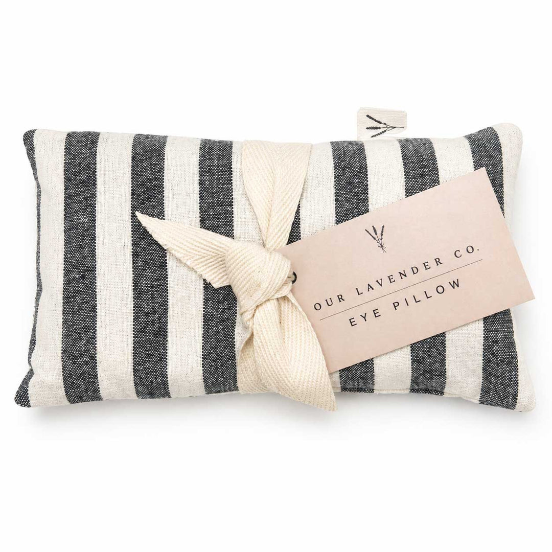 Striped eye pillow with a tag on a white background