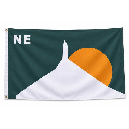 A square flag with a dark green field, a large white mountain shape, a yellow-orange sun, and the letters "NE" in white near the upper left. The left edge has a white header with metal grommets.