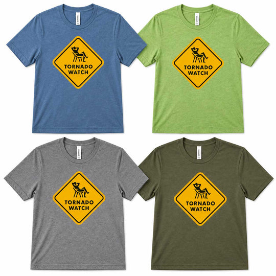 Four short-sleeve crewneck t-shirts shown in blue, green, gray, and olive green, each featuring a yellow diamond-shaped 'Tornado Watch' warning sign graphic on the chest.