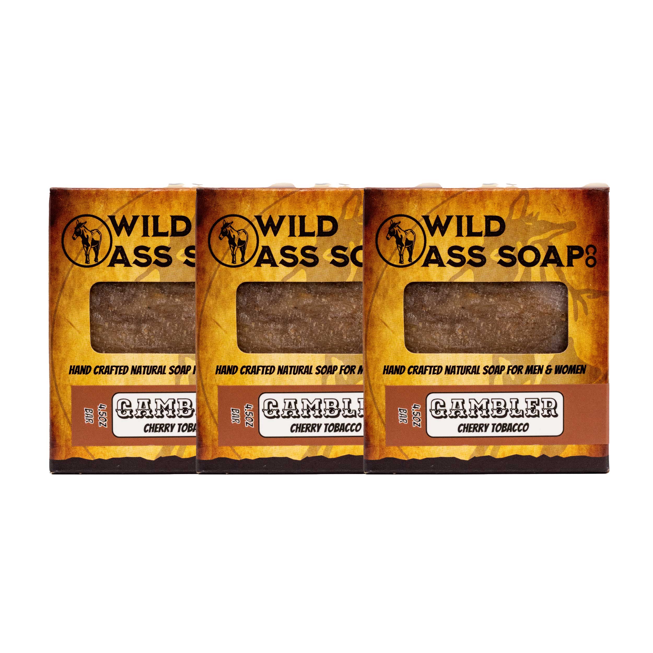 Three bars of Wild Ass Soap in wooden packaging with 'Gambler' label on a white background.