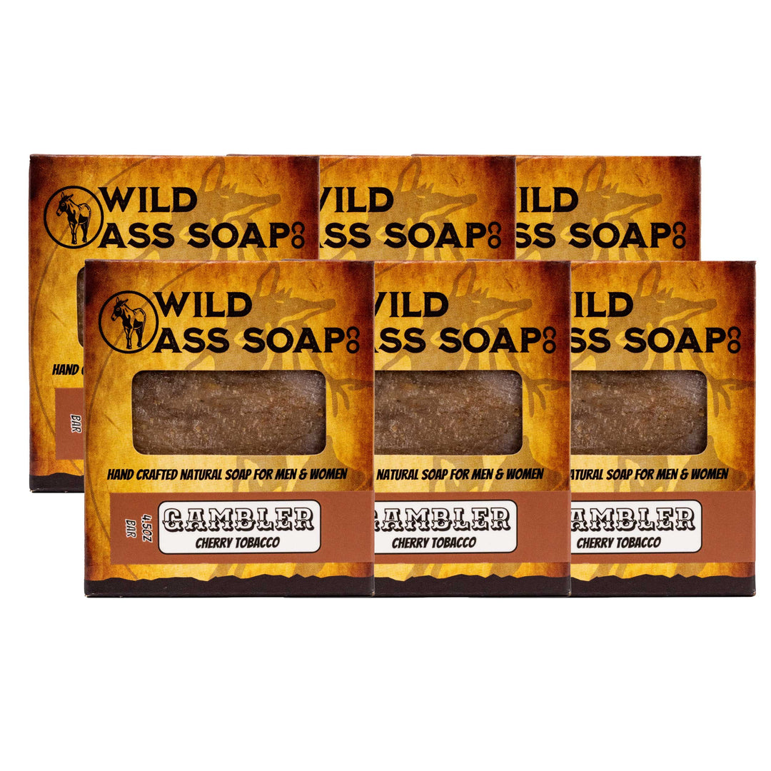 Three bars of Wild Ass Soap with 'Gambler' flavor packaging on a white background