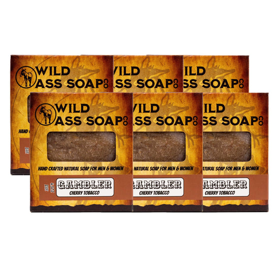 Three bars of Wild Ass Soap with 'Gambler' flavor packaging on a white background