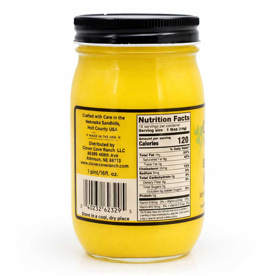 Yellow jar with black lid and nutrition label on a white background