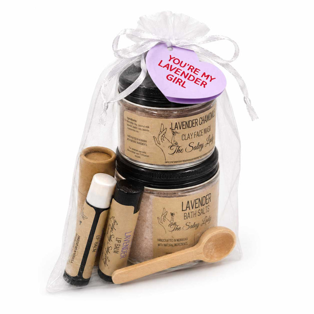 Set of lavender-themed skincare products in a clear bag with a tag, on a white background.