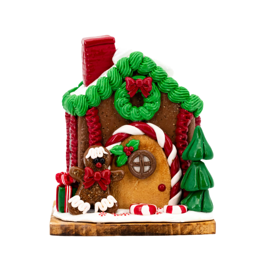 Decorative gingerbread house with candy decorations on a white background