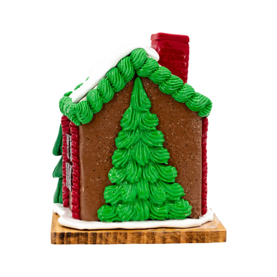 Gingerbread house with green tree design on a white background