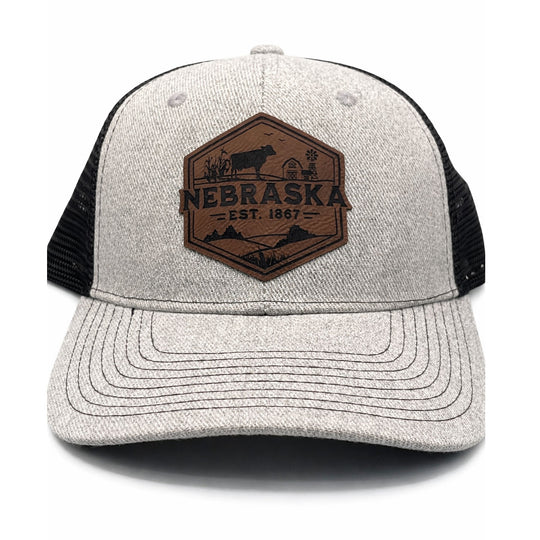Gray and black cap with a brown 'Nebraska' logo on a white background