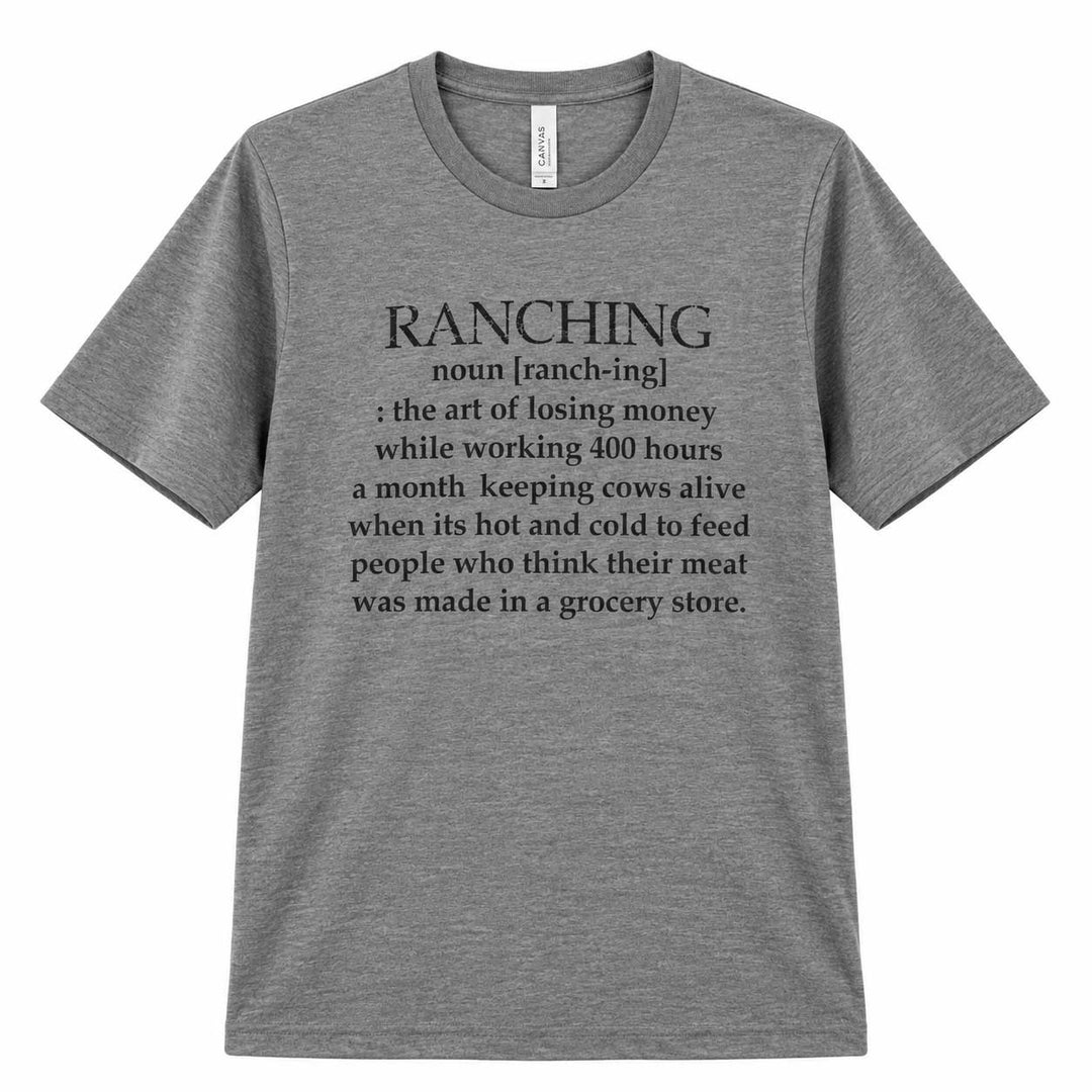 A heather gray short-sleeve crewneck t-shirt featuring a black printed dictionary-style definition of the word 'RANCHING' on the front, displayed against a solid white background.