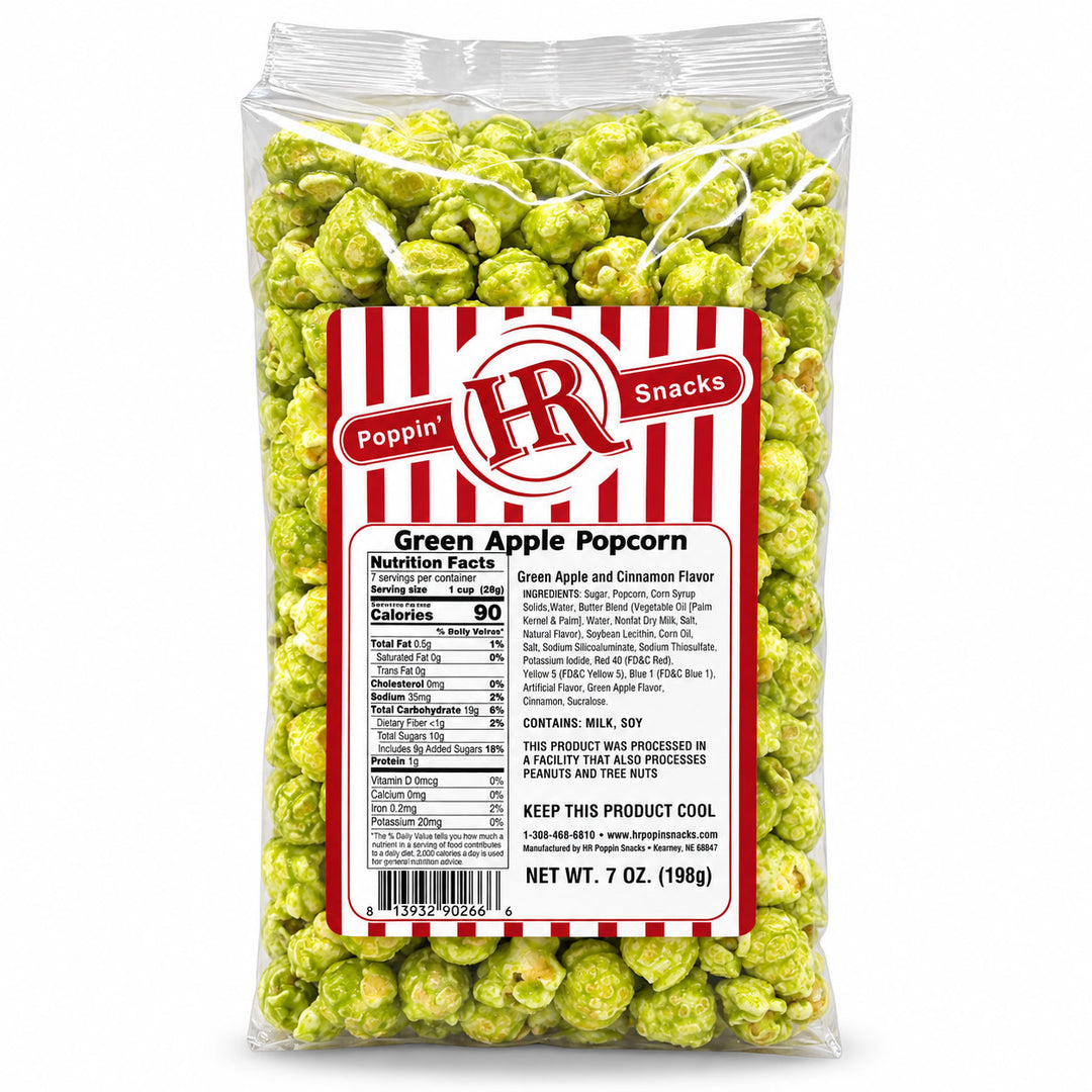 A 7 oz bag of green apple popcorn with a red and white striped label, photographed on a clean white background.