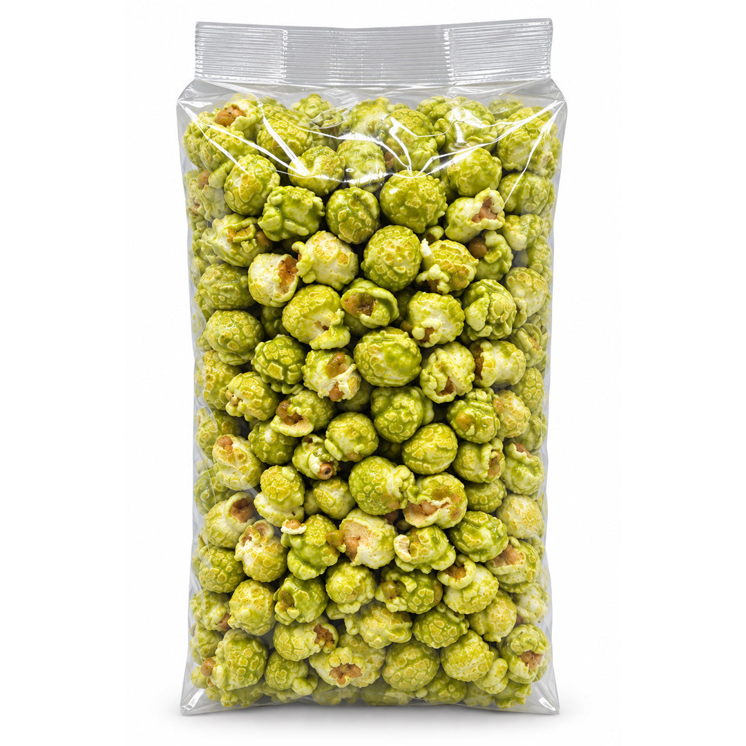 A clear plastic bag filled with green popcorn, photographed against a plain white background.