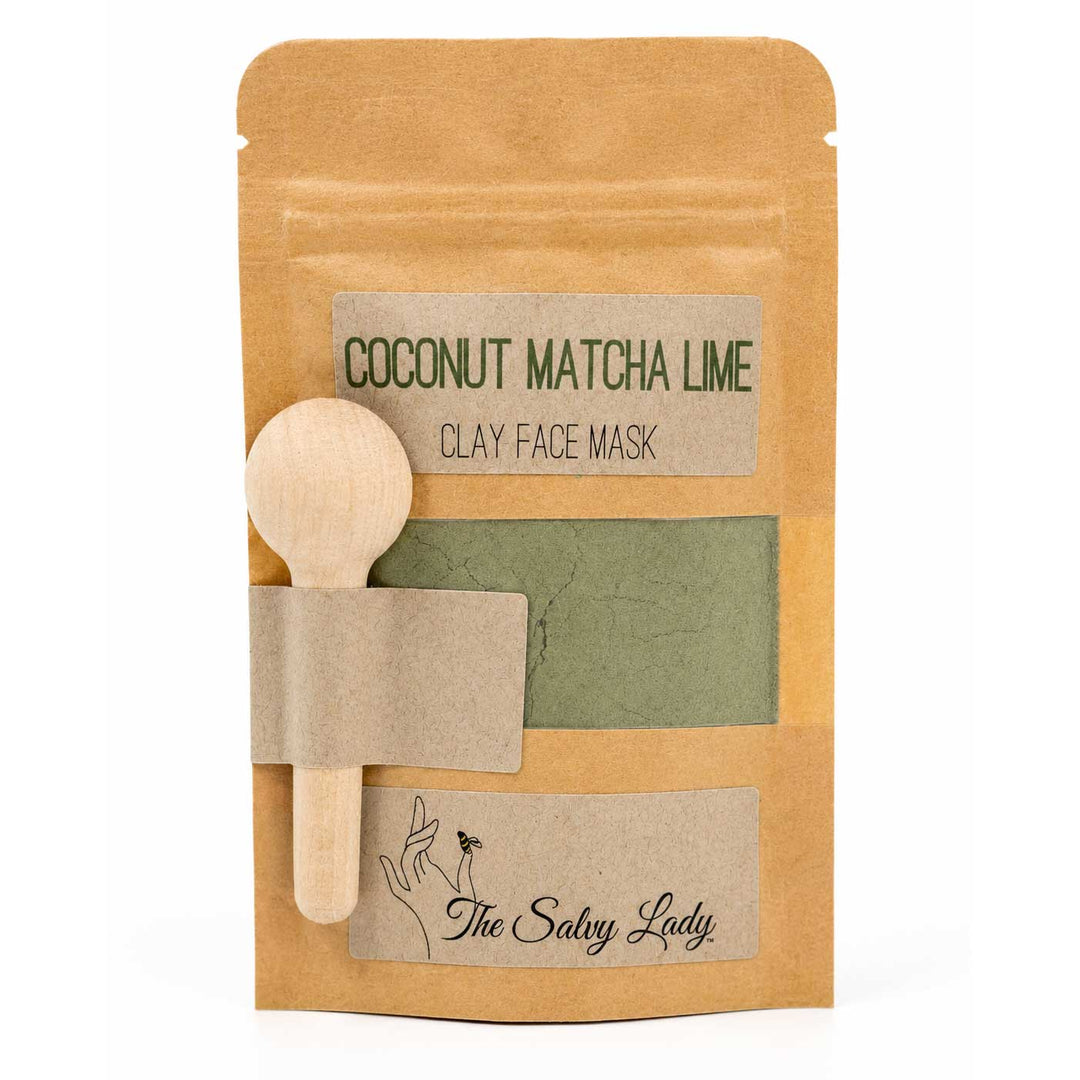 Coconut Matcha Lime clay face mask package with a wooden spoon and green clay sample on a white background.
