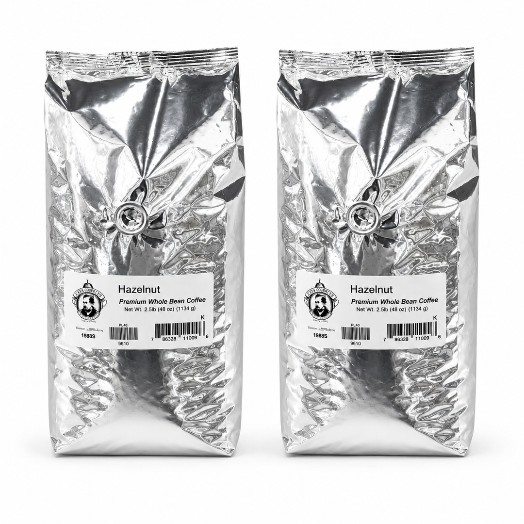 Two packages of hazelnut coffee beans with labels on a white background