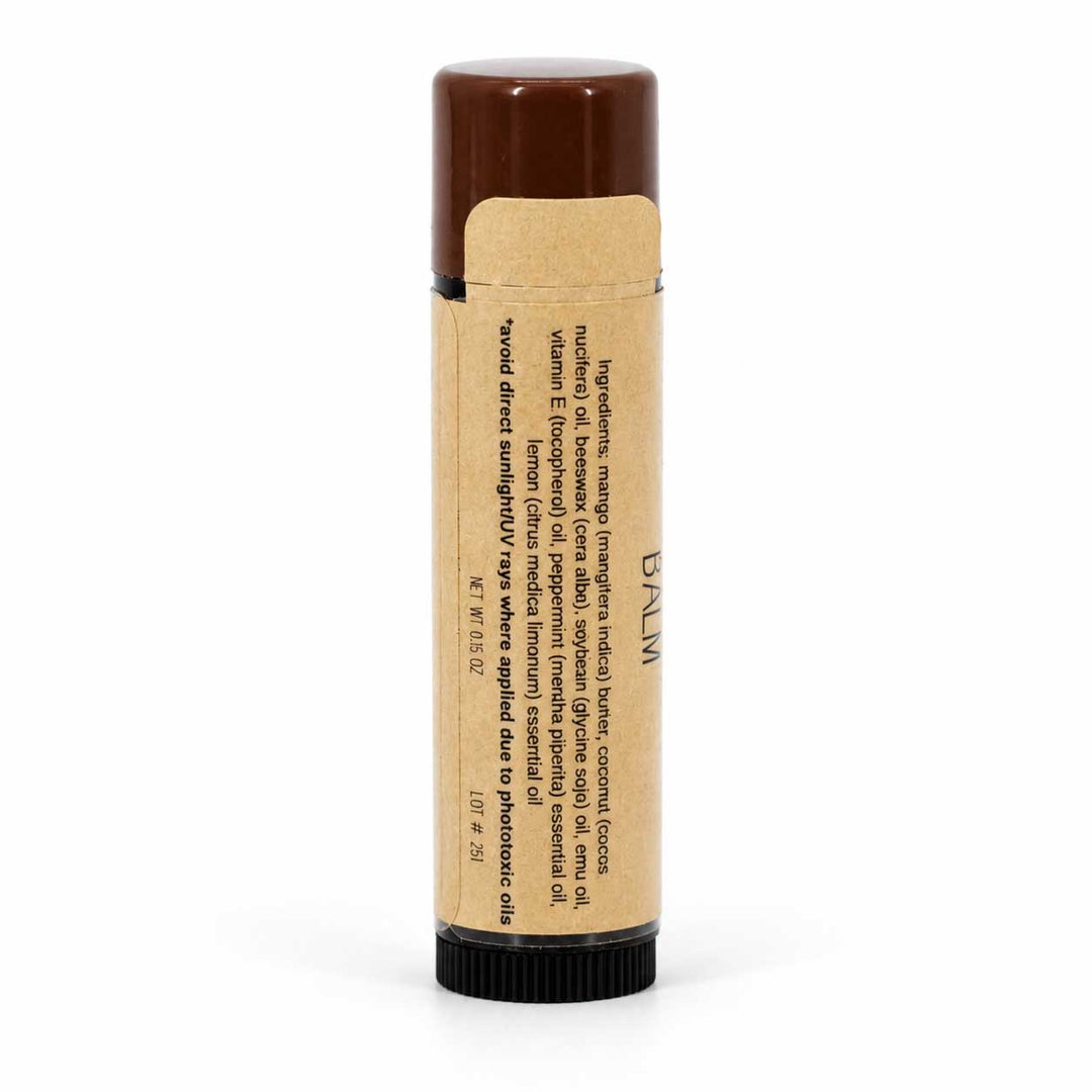 Lip balm with brown cap and visible label on a white background