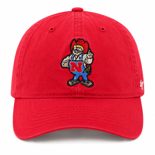A red baseball cap featuring an embroidered mascot character on the front with a large red 'N' on the chest, photographed against a clean white background.