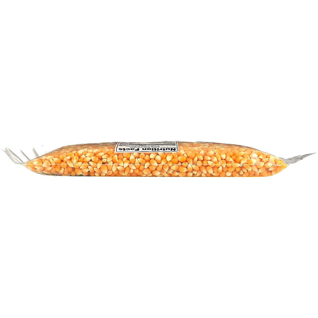 A clear plastic bag filled with yellow-orange corn kernels, sealed with silver metal ends and a white label in the center, shown on a plain white background.