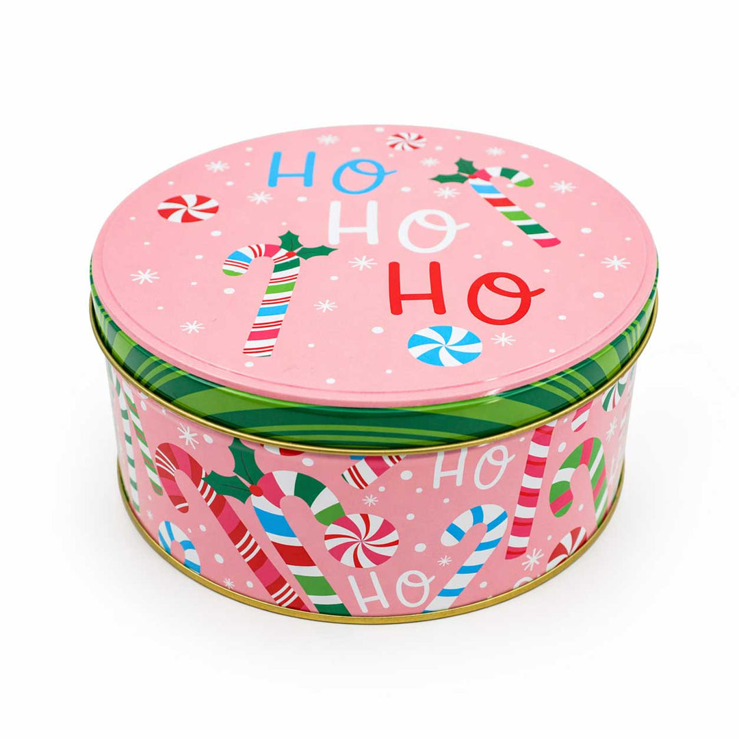 Round Christmas-themed tin with pink lid and candy cane design on a white background