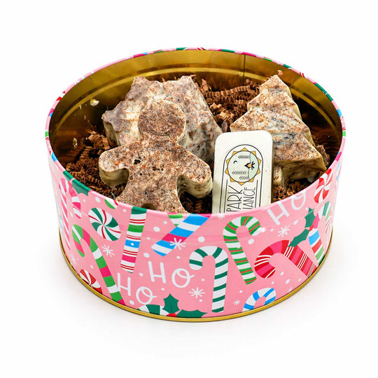 Decorative tin with Christmas-themed design containing wax fire starters.