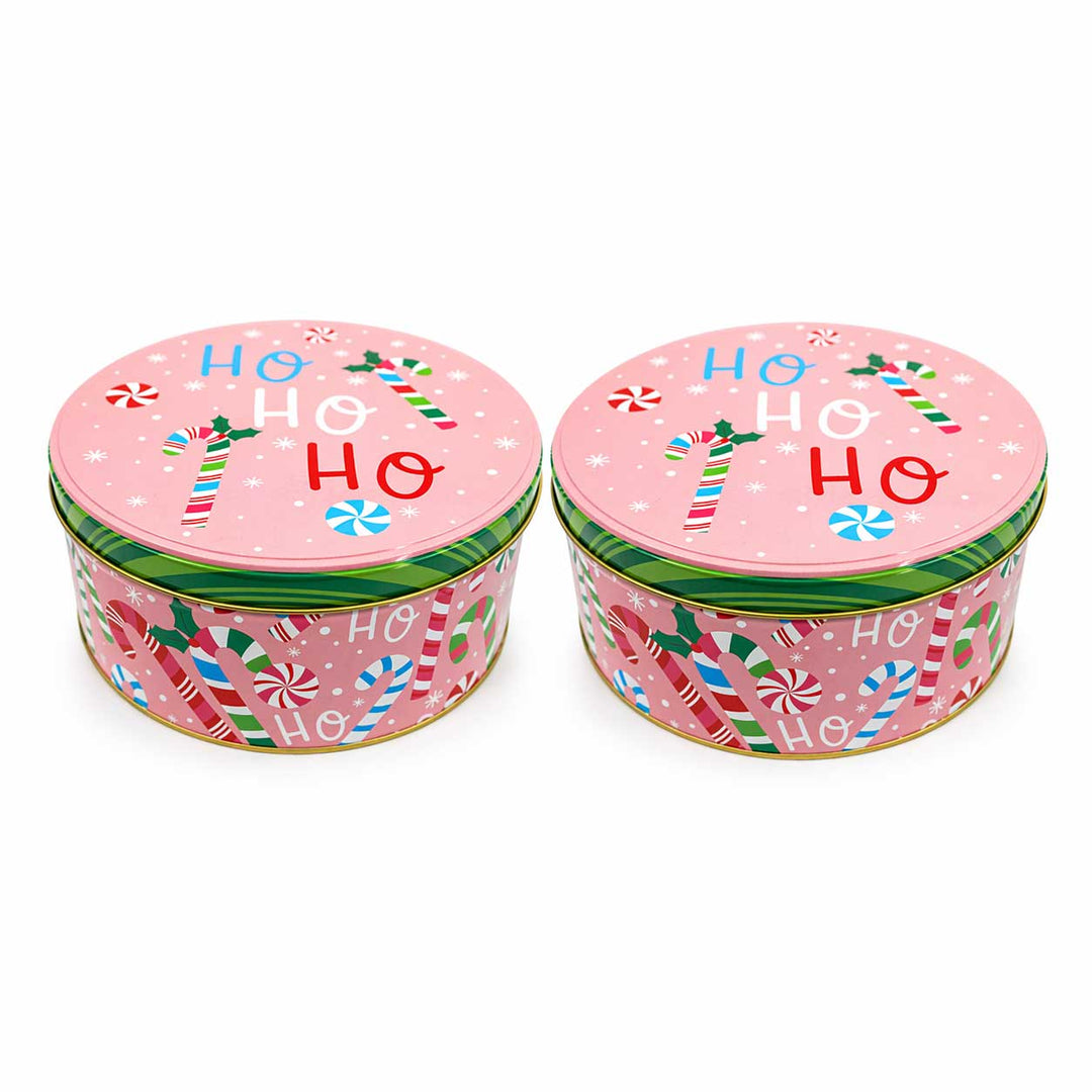 Two pink Christmas tins with candy cane design and 'HO HO HO' text on a white background.