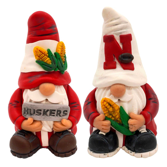 Two Husker gnomes in red outfits with corn and 'N' symbols on a white background