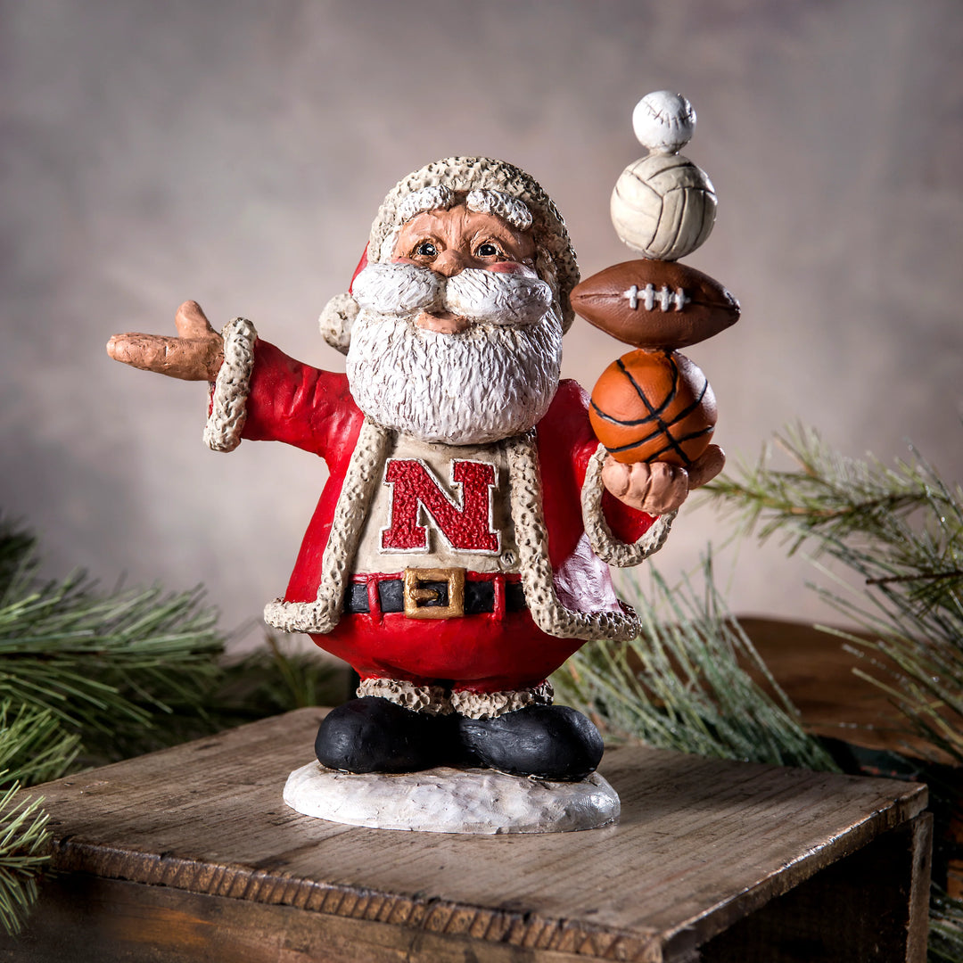 Santa Claus figurine with sports balls on a wooden platform