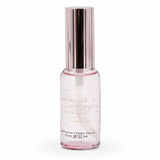 Pink skincare serum bottle with silver cap on a white background