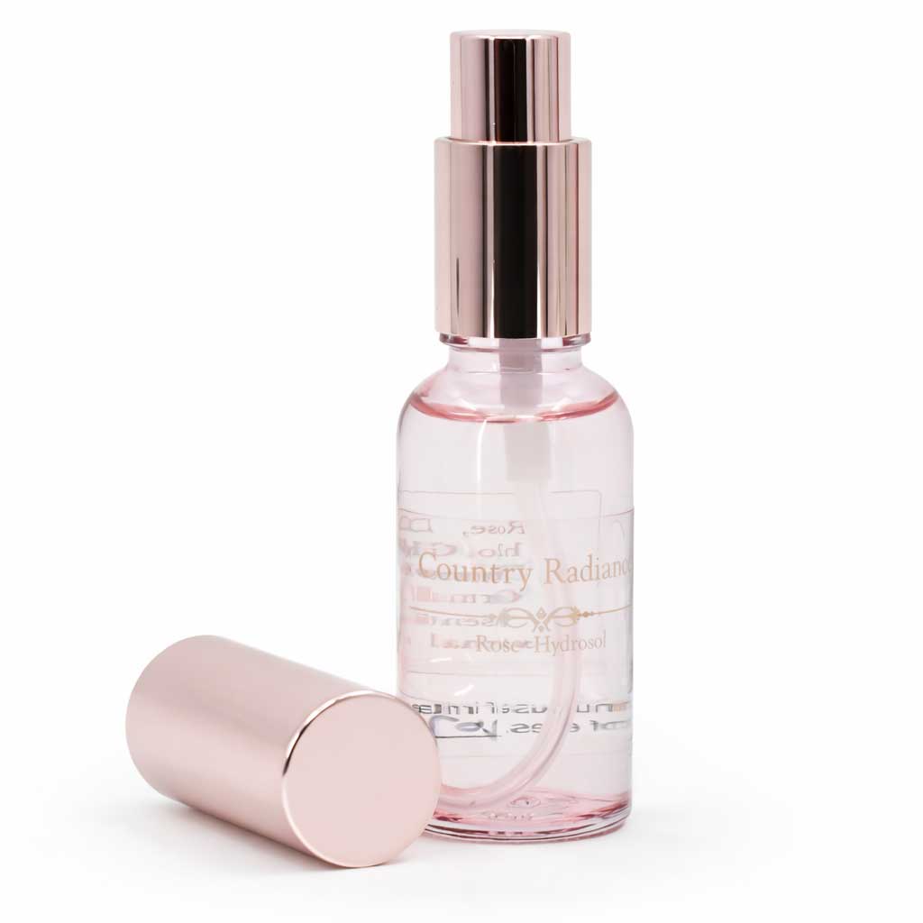 Pink perfume bottle with rose gold cap on a white background