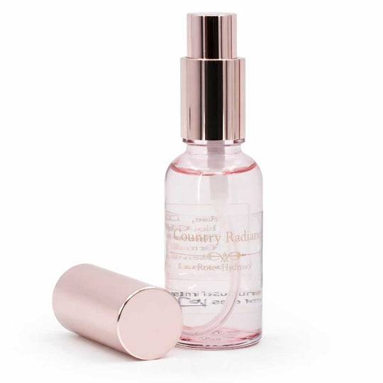 Pink perfume bottle with rose gold cap on a white background