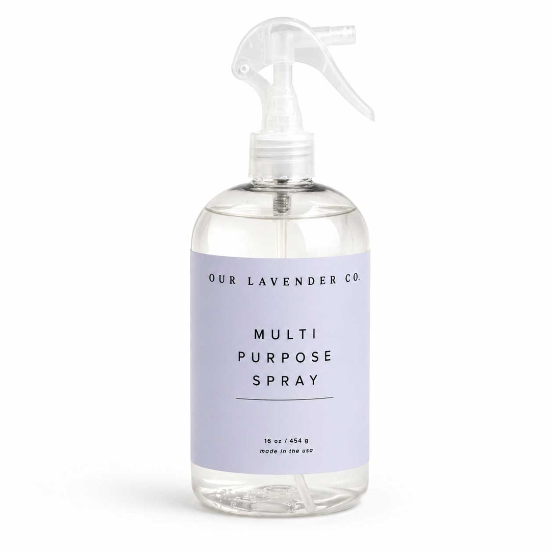 Clear spray bottle with lavender label on a white background