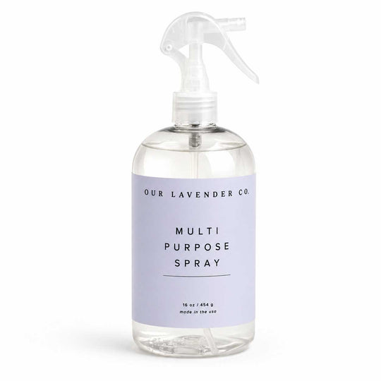 Clear spray bottle with lavender label on a white background