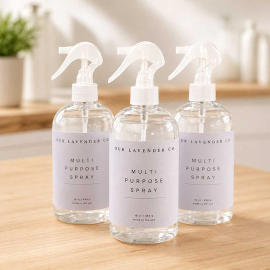 Three multi-purpose spray bottles on a wooden surface with a blurred background