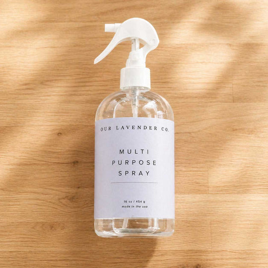 Clear spray bottle with white label on a wooden surface