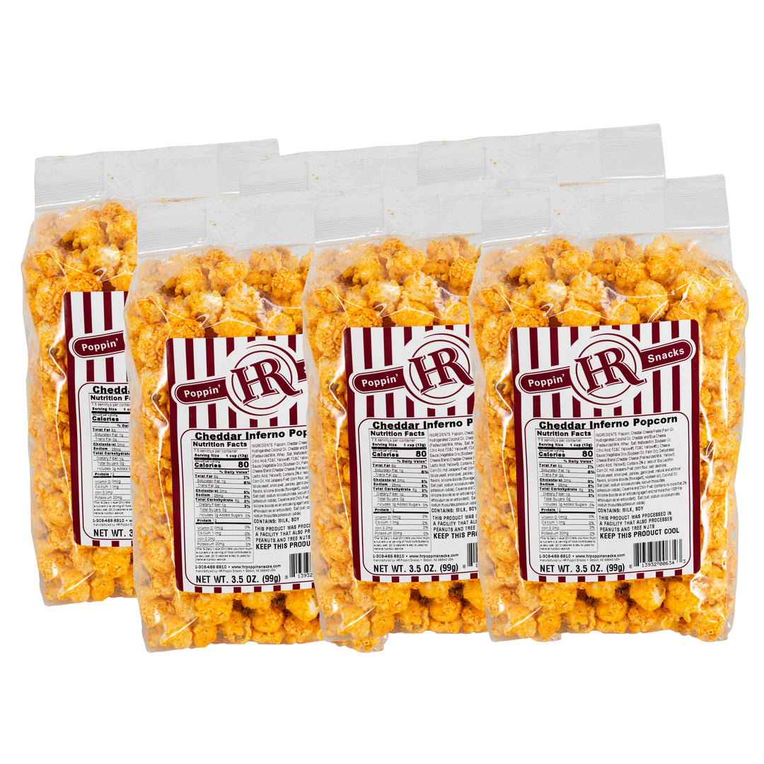 Six bags of cheddar inferno popcorn with red and white labels on a white background