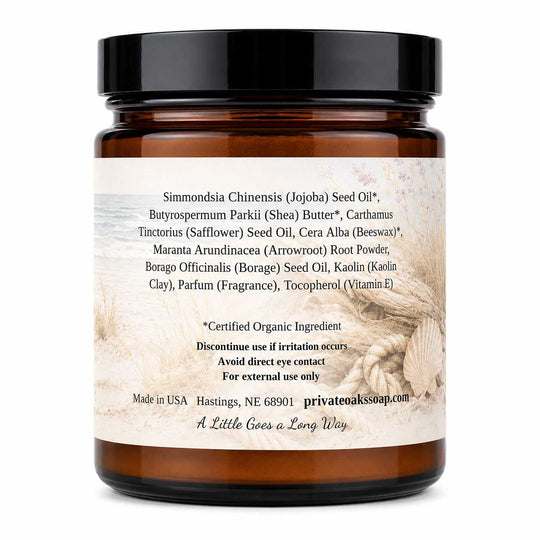 An amber glass jar of Private Oak Soap body butter with a black lid and a beige label detailing ingredients, photographed on a white background.