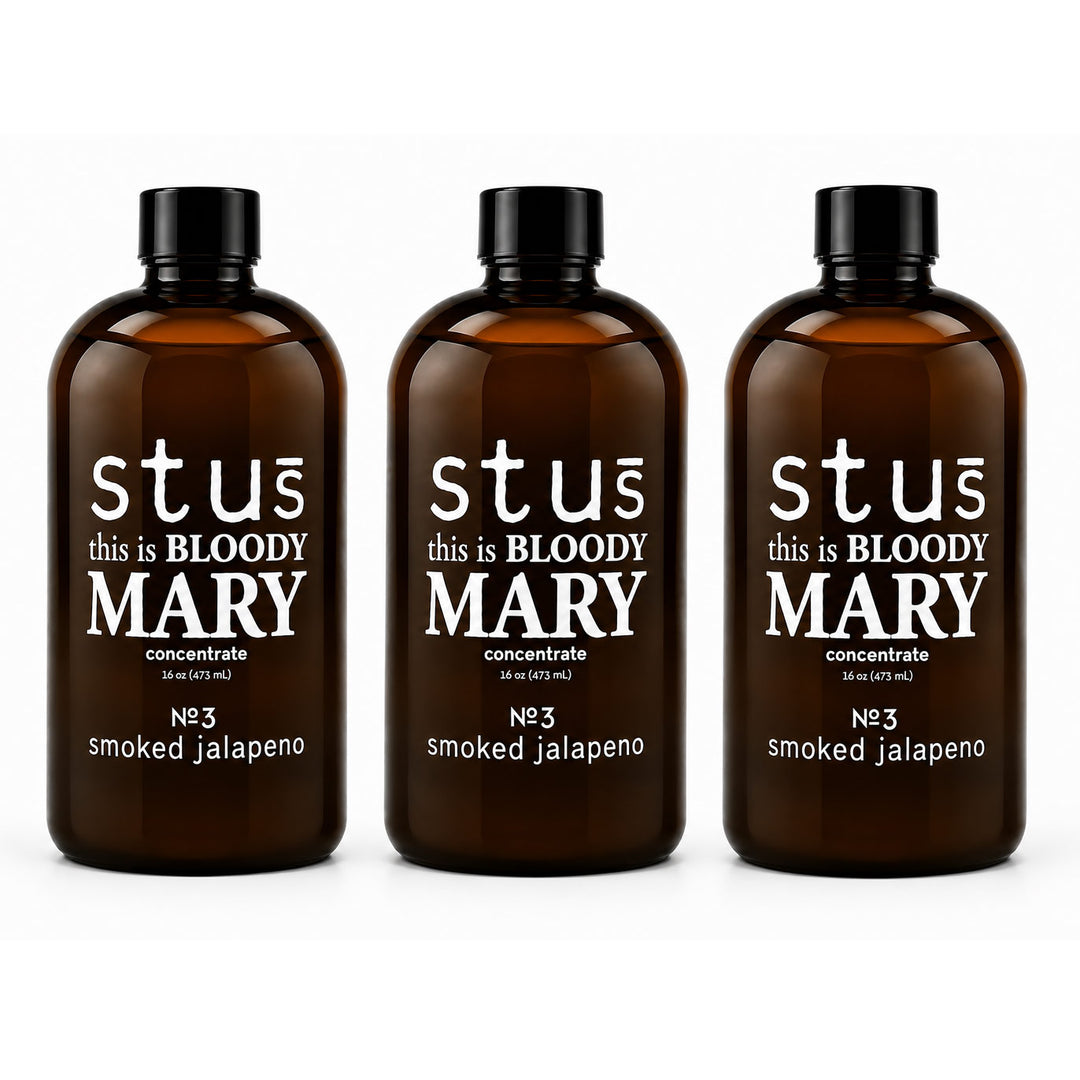 Three amber glass bottles with black caps and white text reading 'st us this is BLOODY MARY concentrate No.3 smoked jalapeno' on a clean white background.
