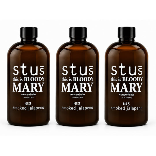 Three amber glass bottles with black caps and white text reading 'st us this is BLOODY MARY concentrate No.3 smoked jalapeno' on a clean white background.