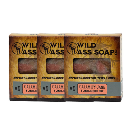 Three bars of Wild Ass Soap with packaging on a white background