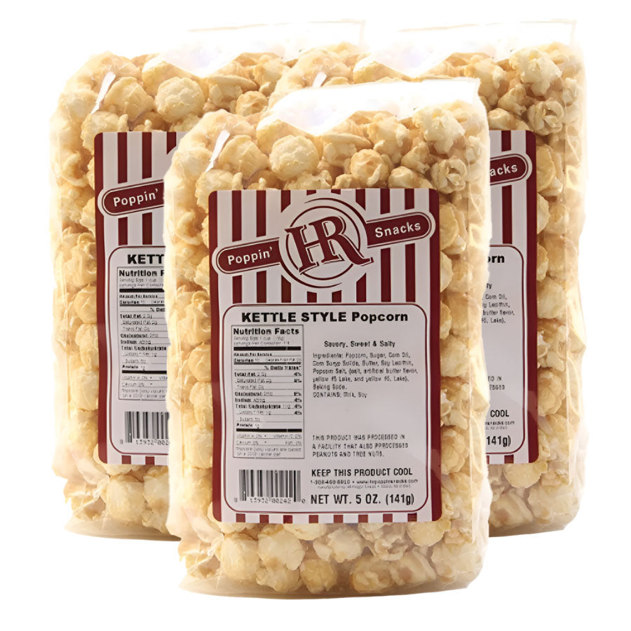 Three bags of kettle style popcorn with visible labels on a white background